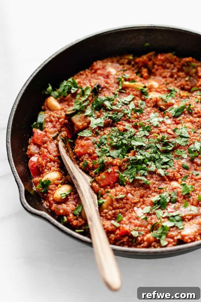 Hearty Vegan Shakshuka 8 A close-up of a perfectly cooked vegan shakshuka, generously topped with fresh parsley, highlighting its rich texture, vibrant colors, and inviting warmth.