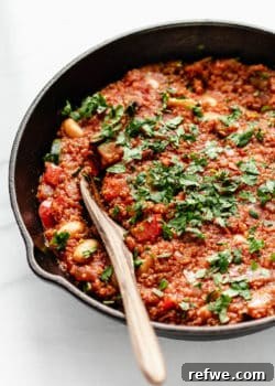 Hearty Vegan Shakshuka 9 A close up of vegan shakshuka topped with parsley, serving as the hero image for the recipe card.