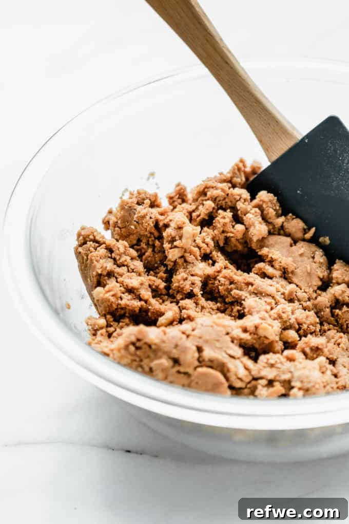Decadent Chocolate Peanut Butter Muscle Bars 6 Peanut butter protein bar dough in a mixing bowl after wet and dry ingredients are combined.