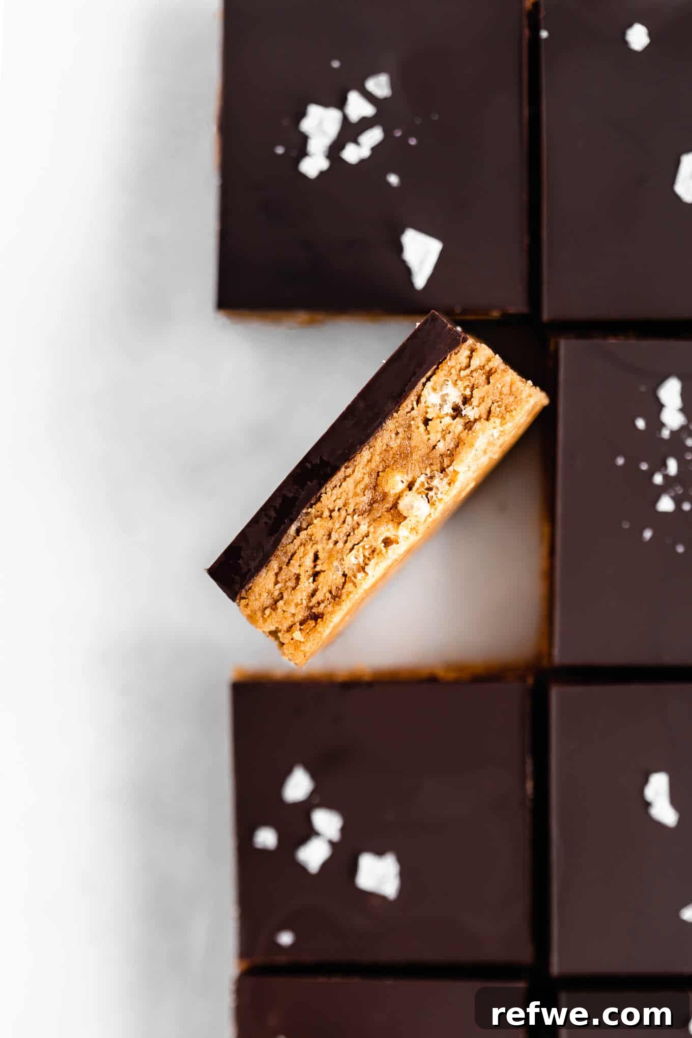 Decadent Chocolate Peanut Butter Muscle Bars 10 A beautifully cut chocolate peanut butter protein bar with a dark chocolate topping and a sprinkling of sea salt.