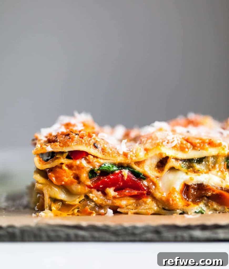 Effortless Elegance: 20 Stunning Date Night Dinners 5 Hearty roasted vegetable lasagna, beautifully topped with melted cheese, presented on a wooden board against a modern grey backdrop, ideal for a comforting date night.