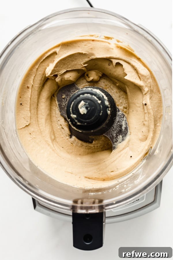 Everything Bagel Seasoned Hummus 4 Hummus being blended to perfection in a food processor.