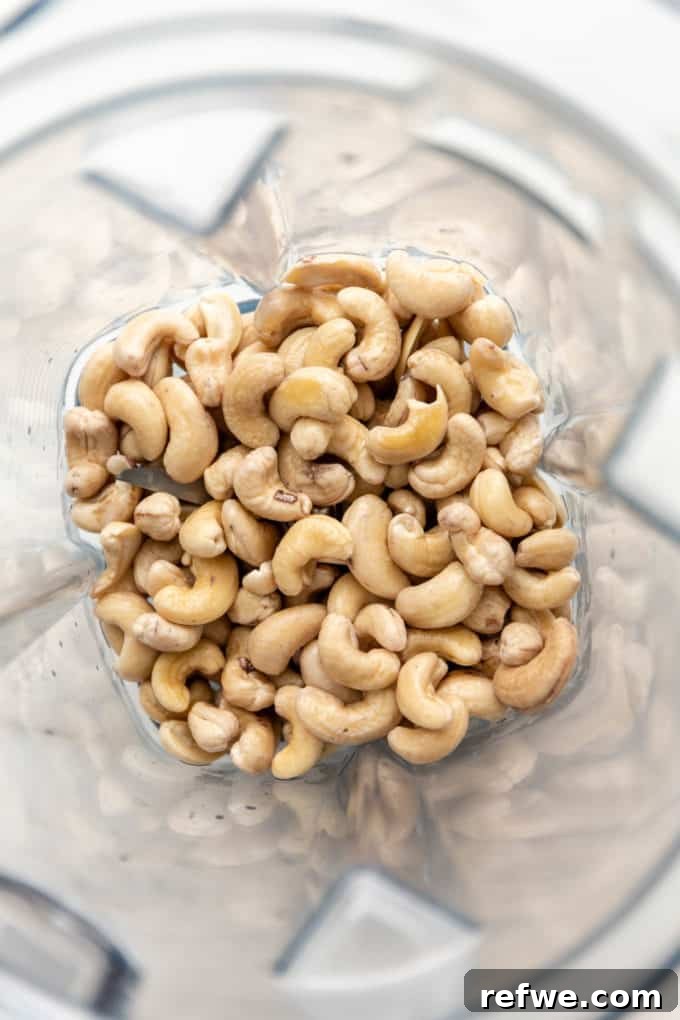 Raw cashews in a blender ready to be processed into cream.