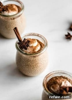 a cup of chai latte chia pudding topped with yogurt, cinnamon and star anis