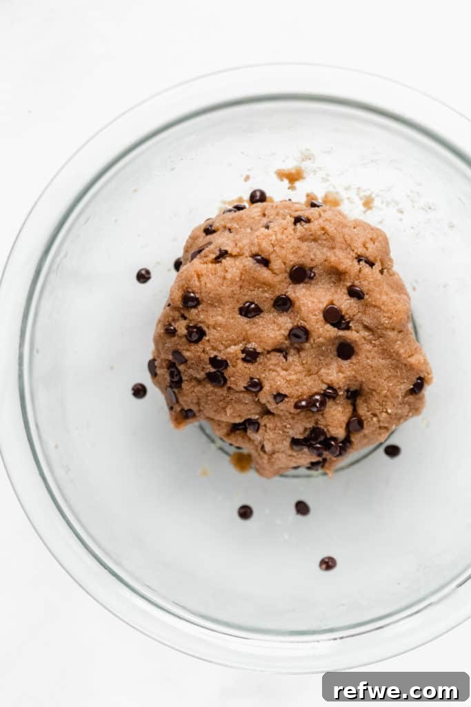Protein Packed Cookie Dough Bites 7 Healthy raw cookie dough with mini chocolate chips folded in, ready for rolling.