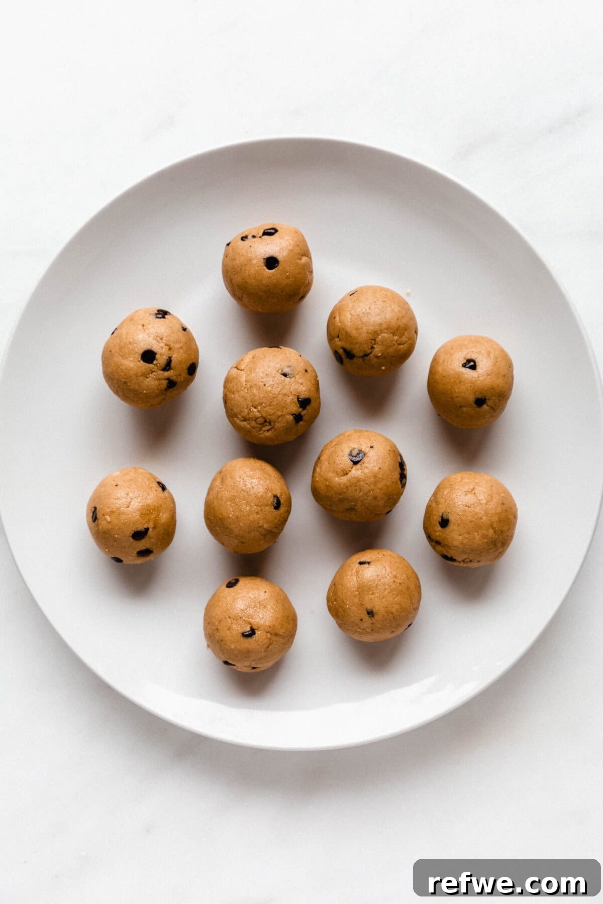 Protein Packed Cookie Dough Bites 8 A plate of perfectly rolled cookie dough protein balls, chilling and ready to be enjoyed.