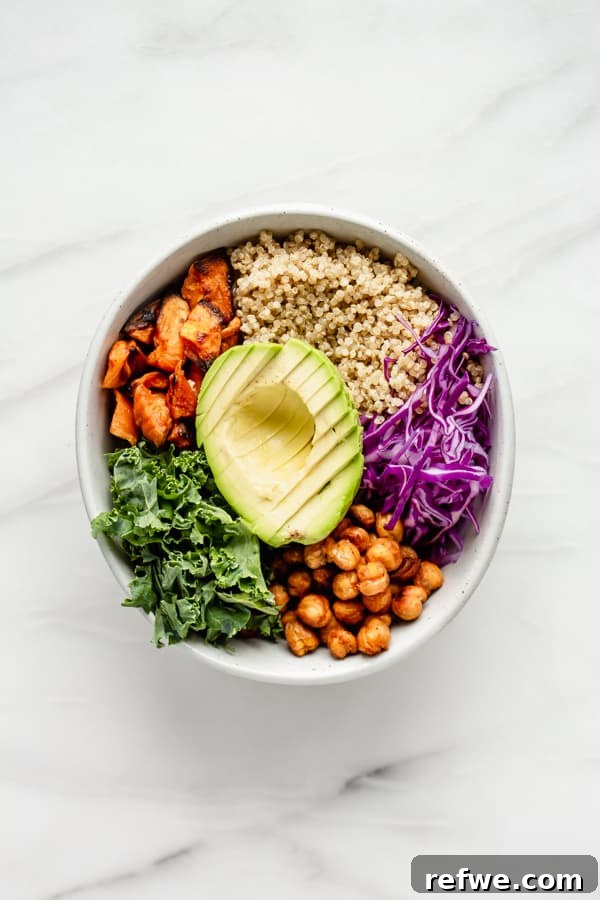 A colorful Buddha bowl filled with fresh vegetables, protein, and grains, ready to eat.