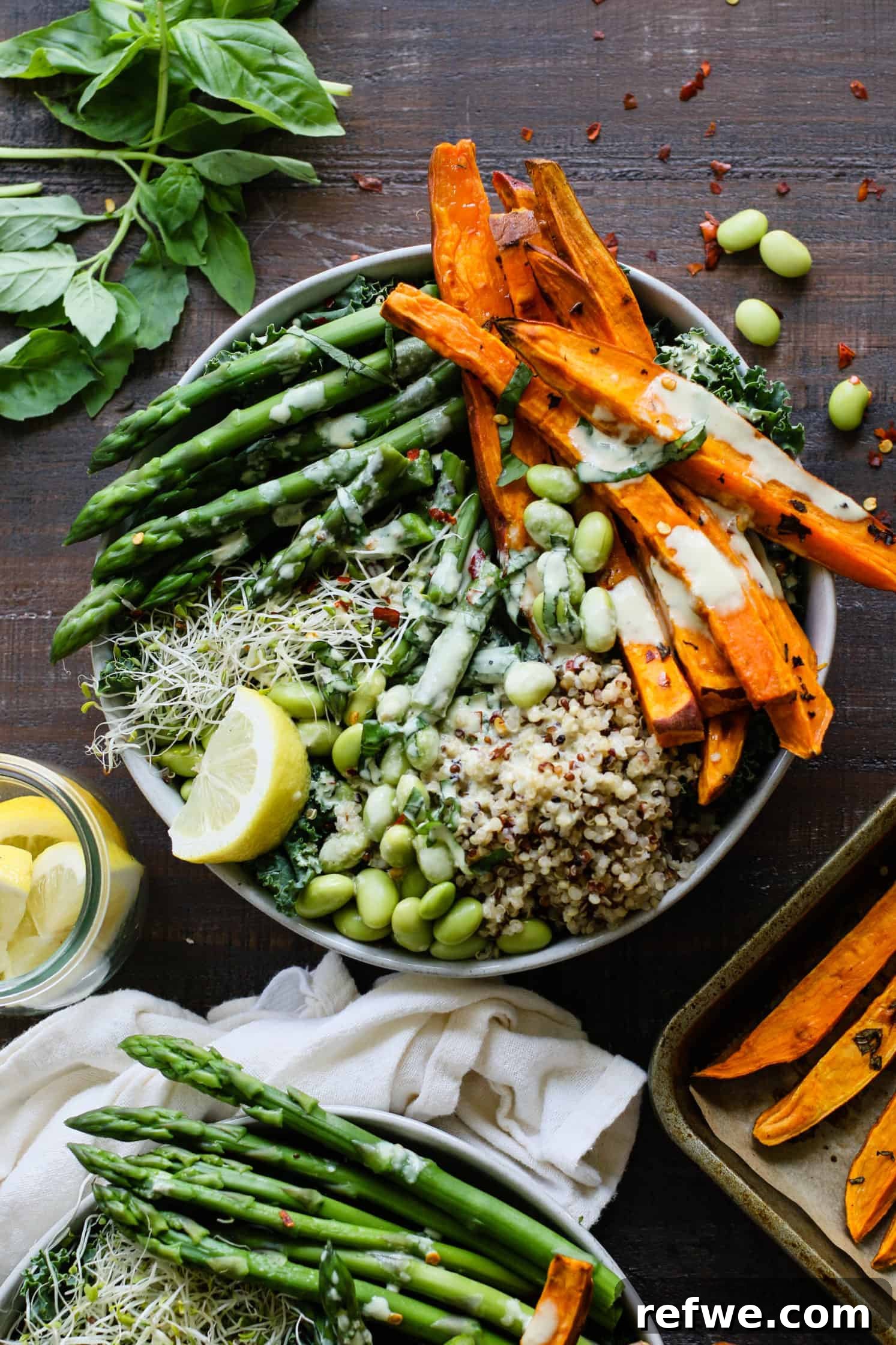 A fresh lemon basil Buddha bowl featuring tender asparagus, vibrant edamame beans, and a creamy lemon tahini dressing.