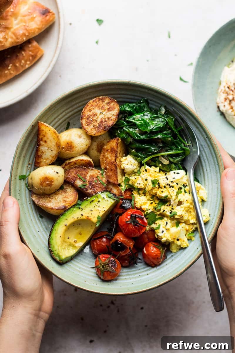 A hearty savory vegan breakfast bowl featuring perfectly scrambled tofu and pan-fried potatoes, creating a satisfying morning meal.