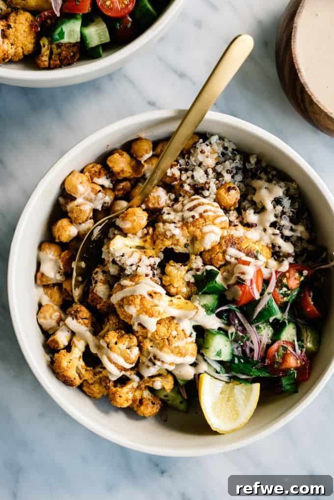 A mouth-watering cauliflower shawarma bowl, beautifully drizzled with creamy tahini sauce, showcasing spiced cauliflower and fresh accompaniments.