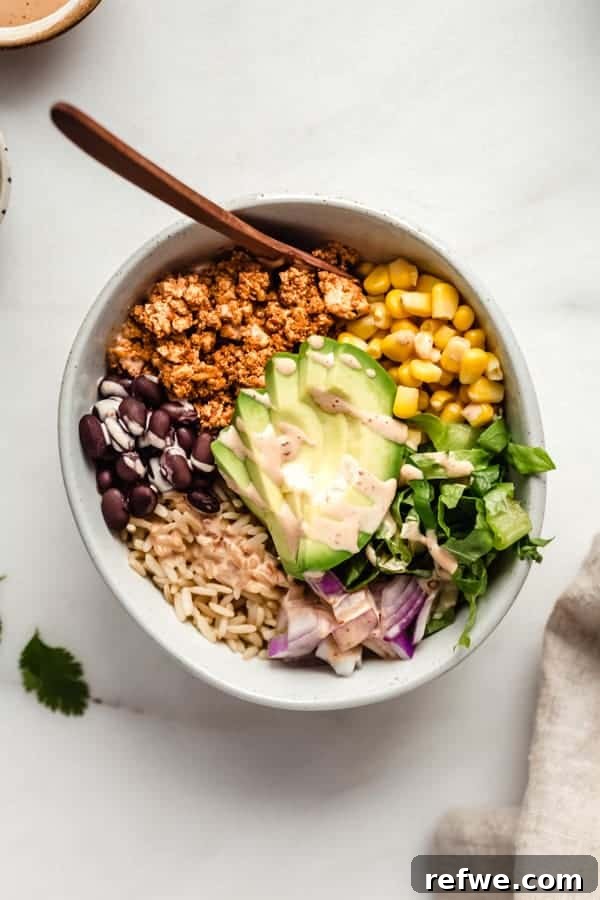 A chipotle sofritas bowl bursting with flavorful beans, sweet corn, crisp lettuce, and seasoned tofu.