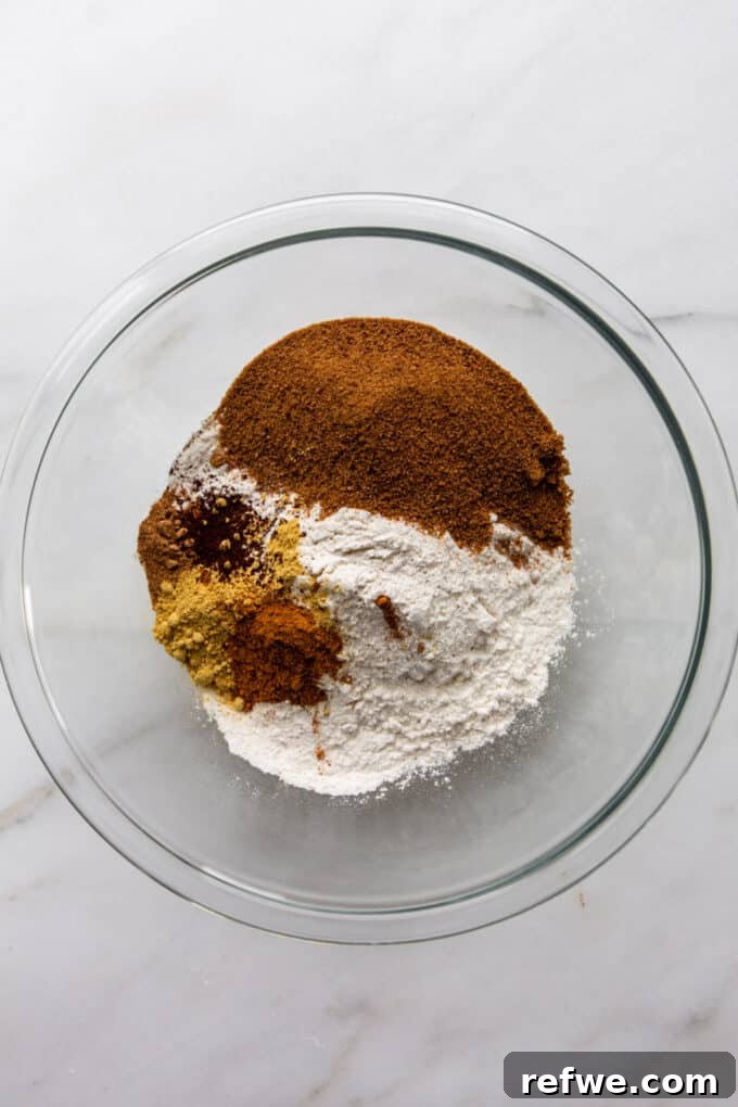 Mixing dry ingredients for gingerbread muffins