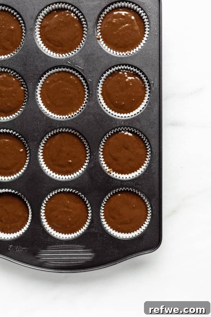 Gingerbread muffin batter in muffin liners