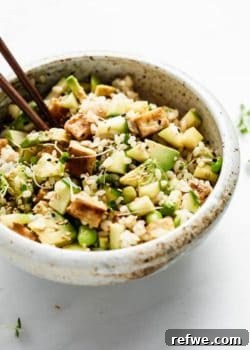 Mixed vegan poke bowl with rice, veggies and tofu with chopsticks