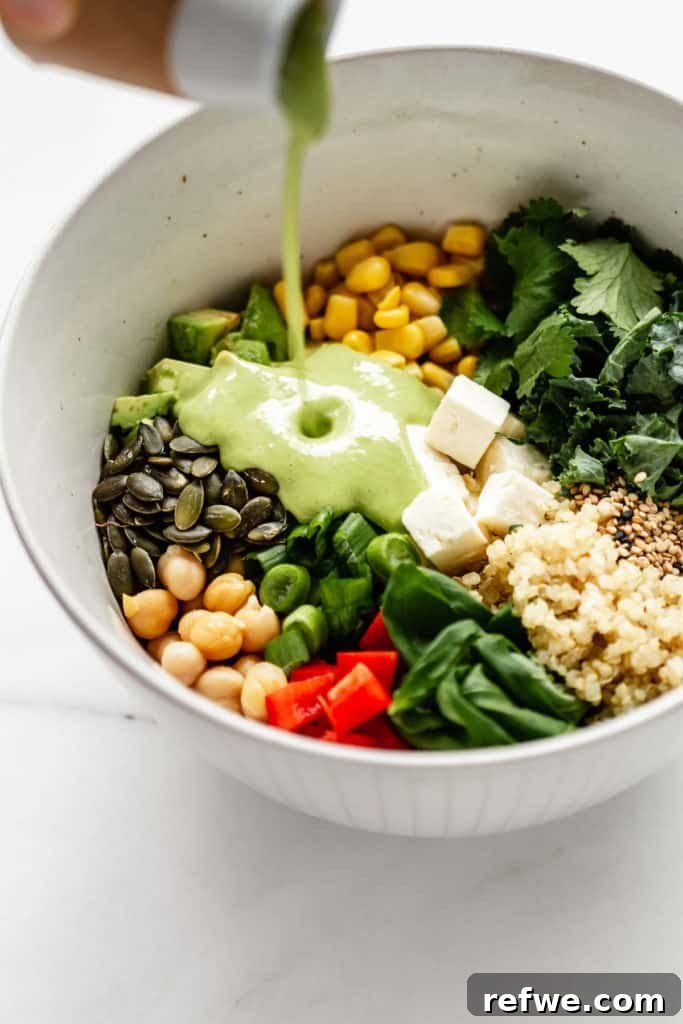 Vibrant Green Goddess Quinoa Bowl 6 Homemade Green Goddess dressing being poured into a bowl of prepared vegetables