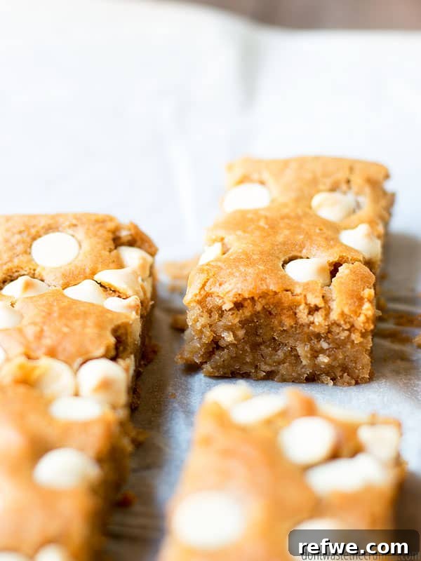 21 Amazing Meals from a Single Can of Beans 22 Golden white bean blondies studded with white chocolate chips on parchment paper