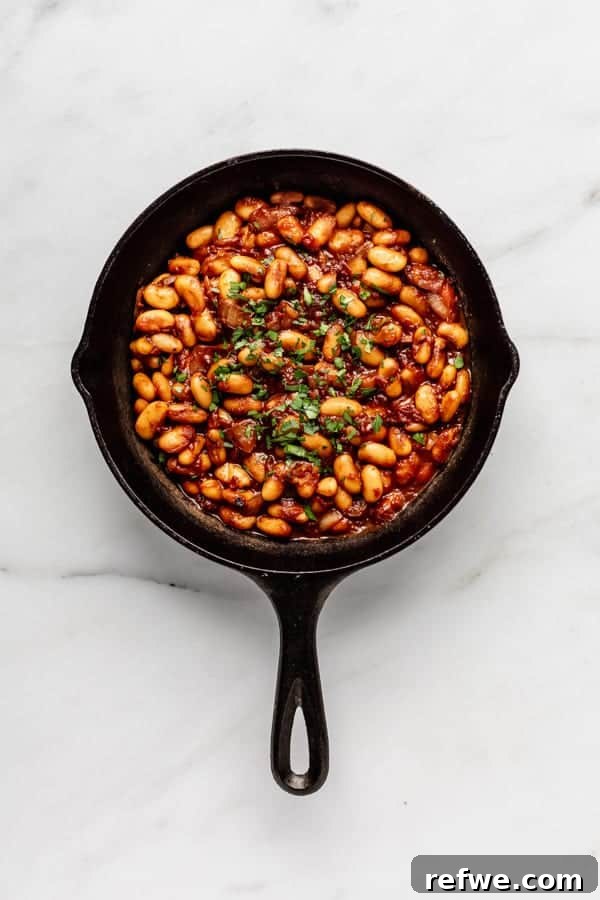 21 Amazing Meals from a Single Can of Beans 8 A cast iron skillet filled with savory and sweet maple baked beans