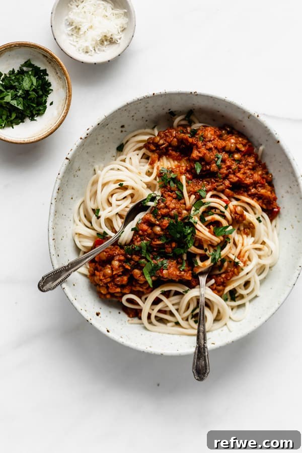 21 Amazing Meals from a Single Can of Beans 10 A comforting bowl of spaghetti topped with rich lentil bolognese, garnished with parsley and parmesan