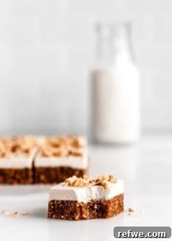 a square of raw carrot cake with a bite taken out of it