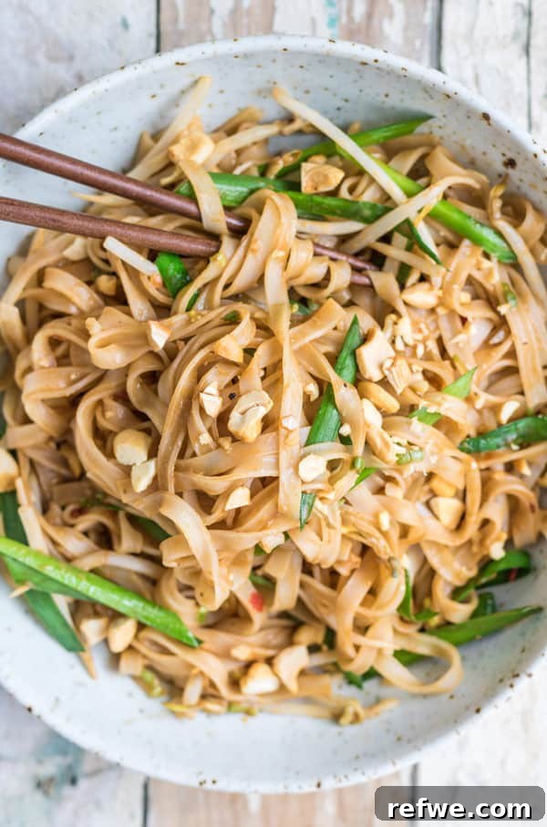 A captivating image of Spicy Sichuan Noodles, showcasing their rich color and inviting texture, garnished with fresh herbs.