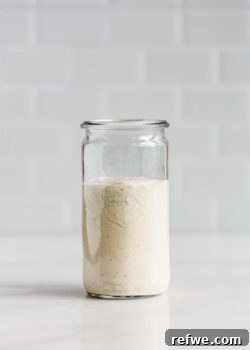 A jar of vegan caesar salad dressing on a white counter