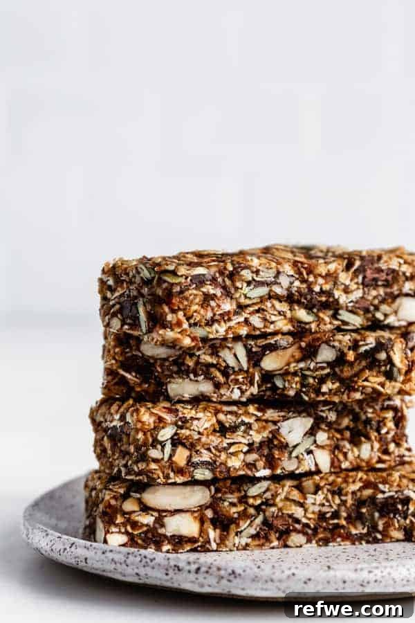 Supercharged Granola Fuel 2 a stack of four superfood granola bars on a white ceramic plate
