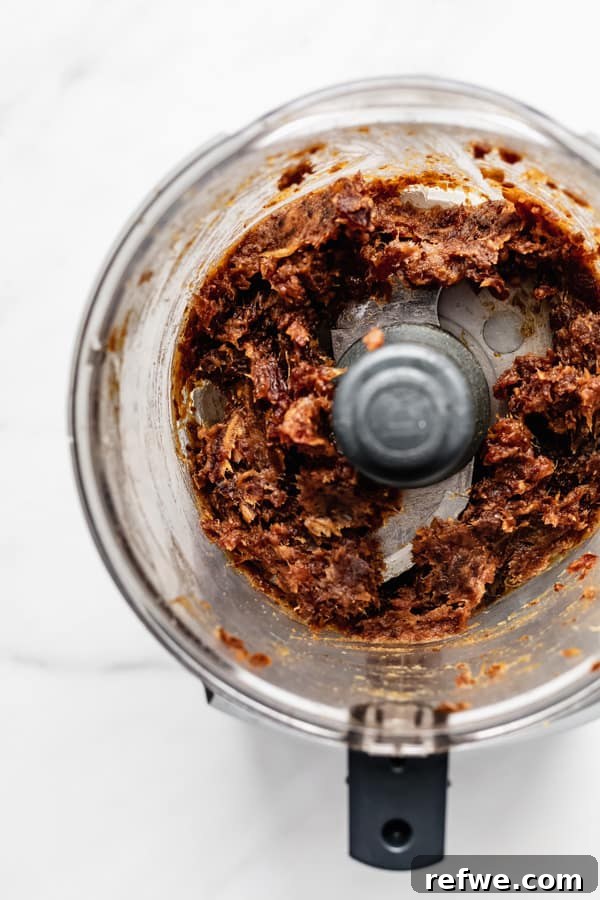 Supercharged Granola Fuel 4 a food processor with date paste in it