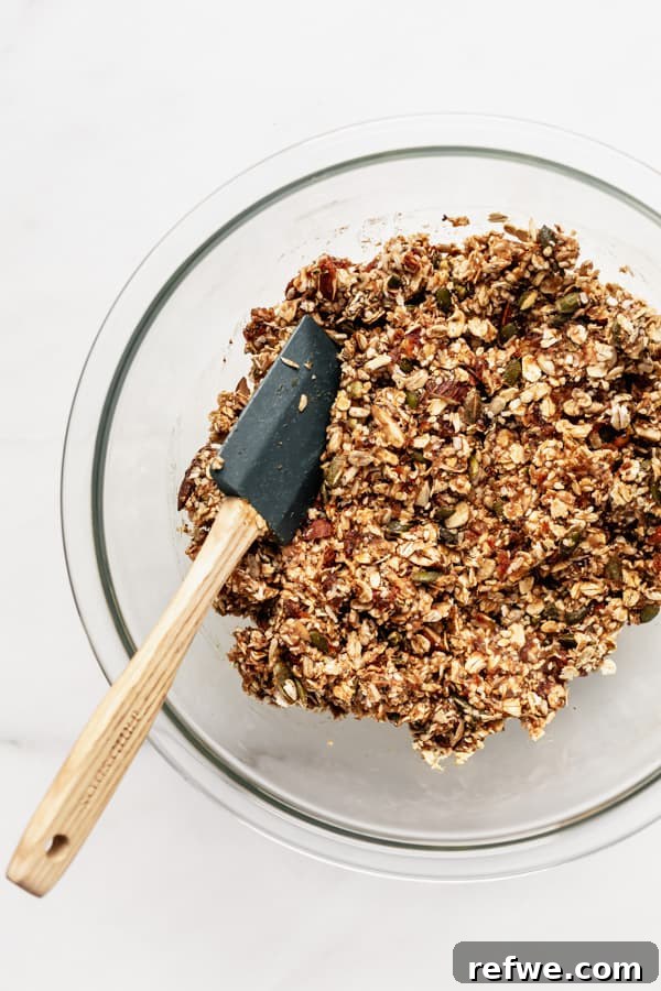 Supercharged Granola Fuel 6 a clear mixing bowl with superfood granola bars ingredients in it