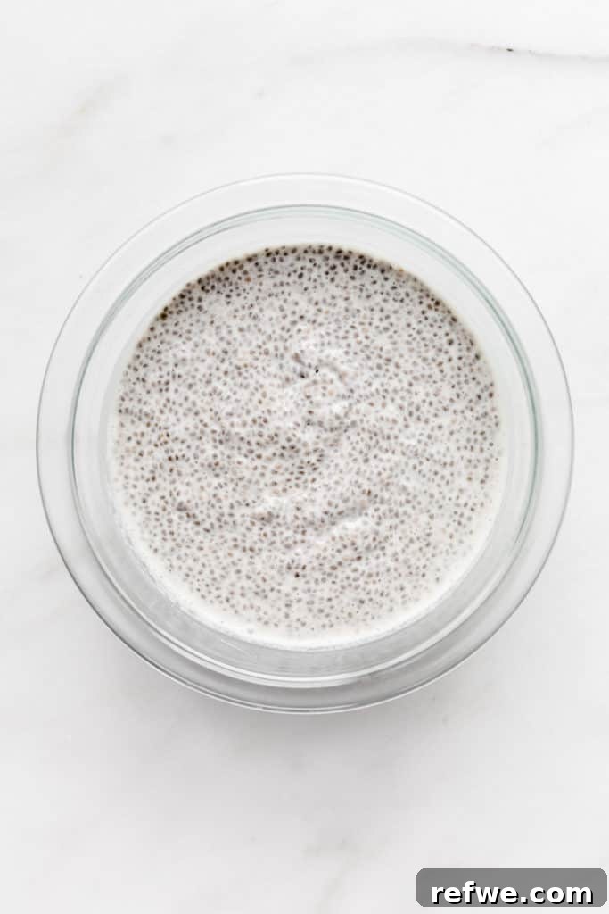 Chia Seeds Unlocked Your Comprehensive Guide to Recipes and Wellness 5 A bowl of creamy vanilla chia pudding, showcasing the finished gel-like texture, garnished with fresh fruit.