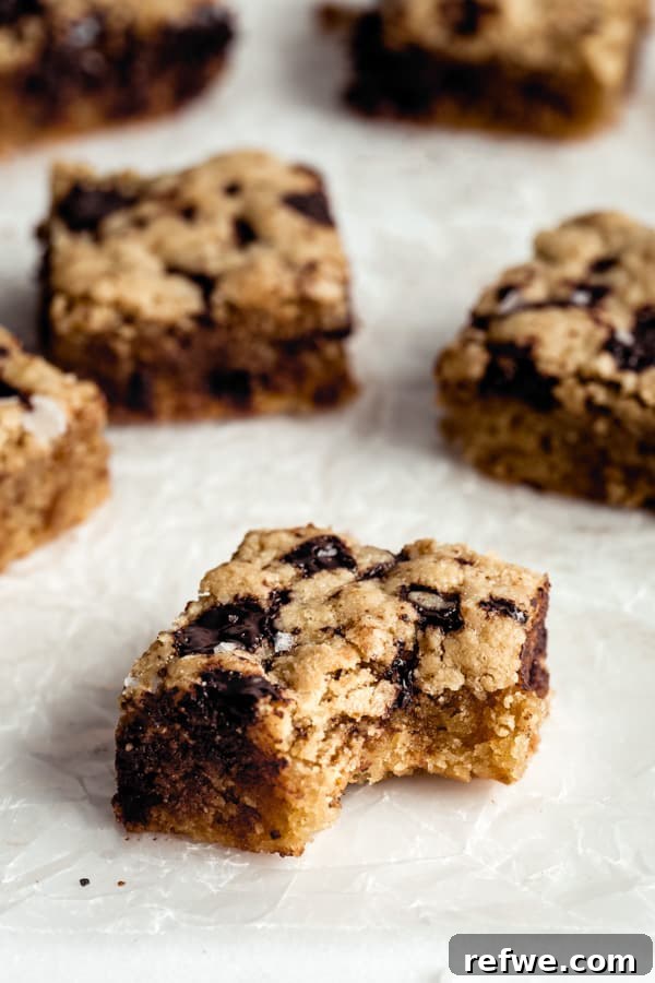 A paleo tahini blondie with a bite taken out, revealing its soft, chewy interior.