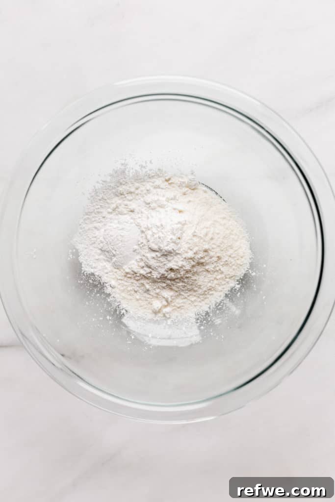 a clear mixing bowl with coconut flour in it