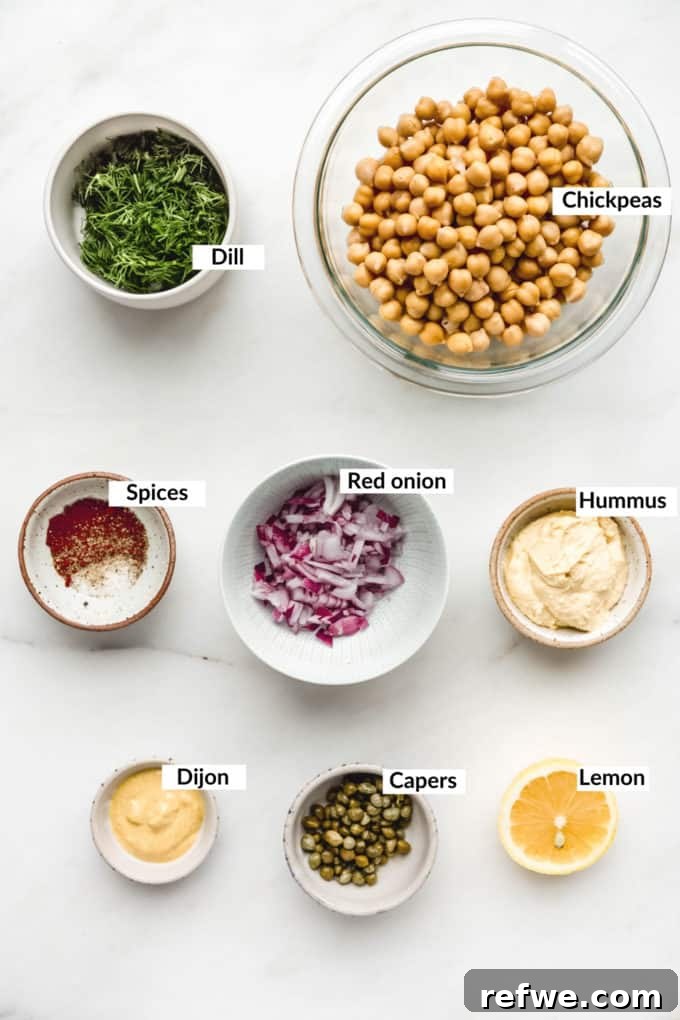 Ingredients for smashed chickpea salad sandwich laid out on a marble board