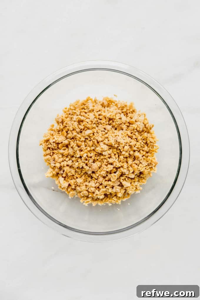 smashed chickpeas in a clear mixing bowl