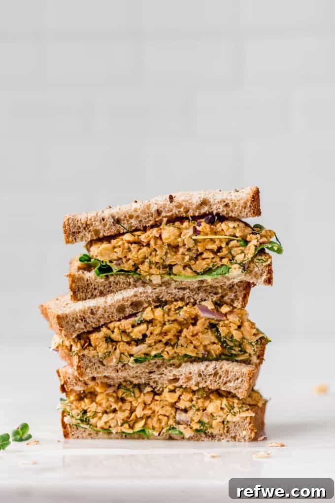 three halves of chickpea salad sandwich stacked