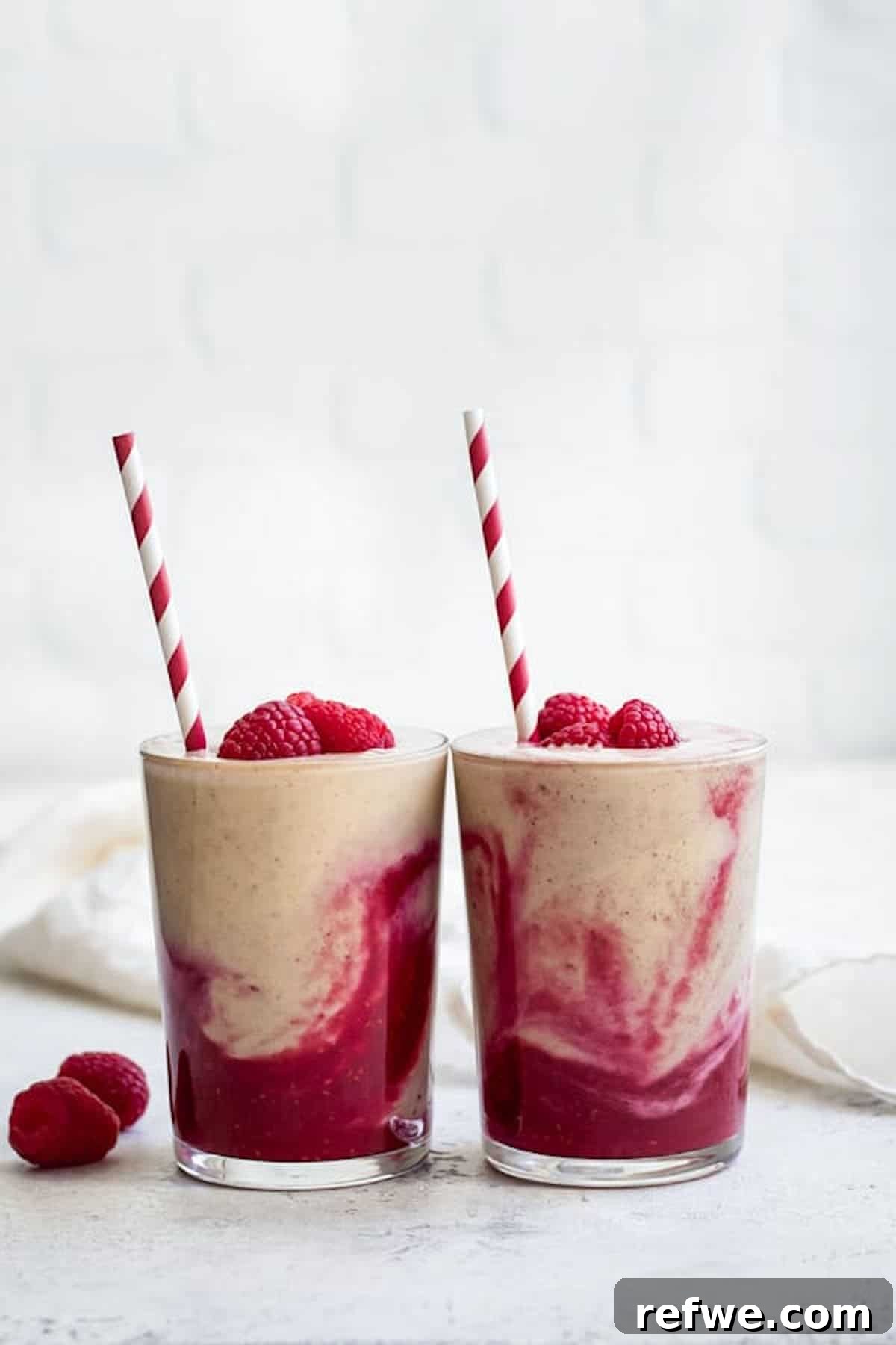 23 Simple Wholesome Morning Smoothies 12 Two peanut butter and jelly smoothies side by side with raspberries on top