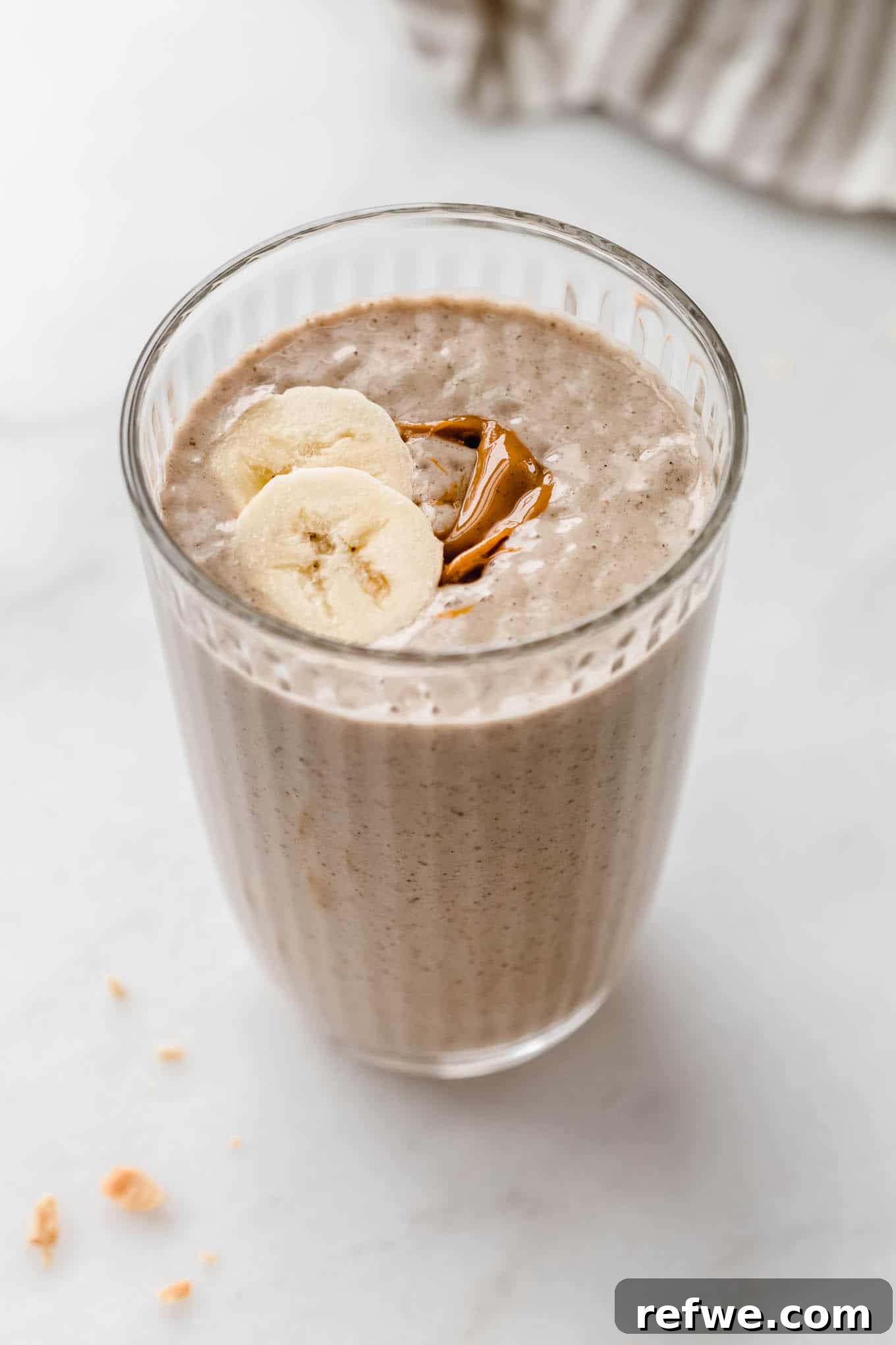 23 Simple Wholesome Morning Smoothies 18 a glass of a peanut butter banana smoothie