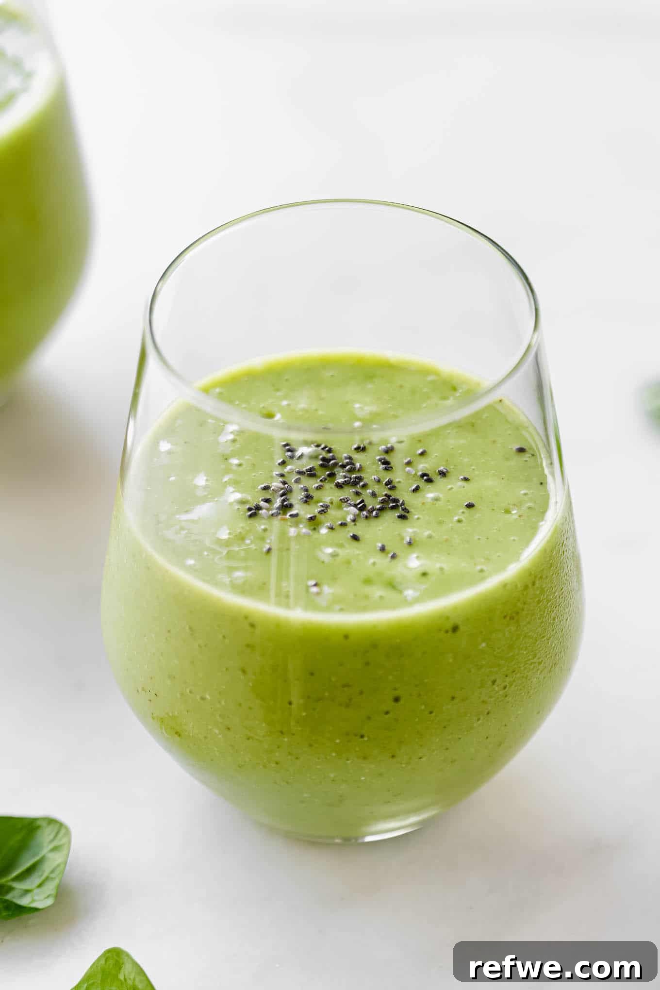 23 Simple Wholesome Morning Smoothies 10 A green smoothie in a glass topped with chia seeds