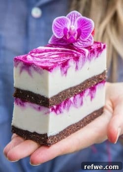 Overhead view of several cut dragon fruit cheesecake bars, ready for serving.