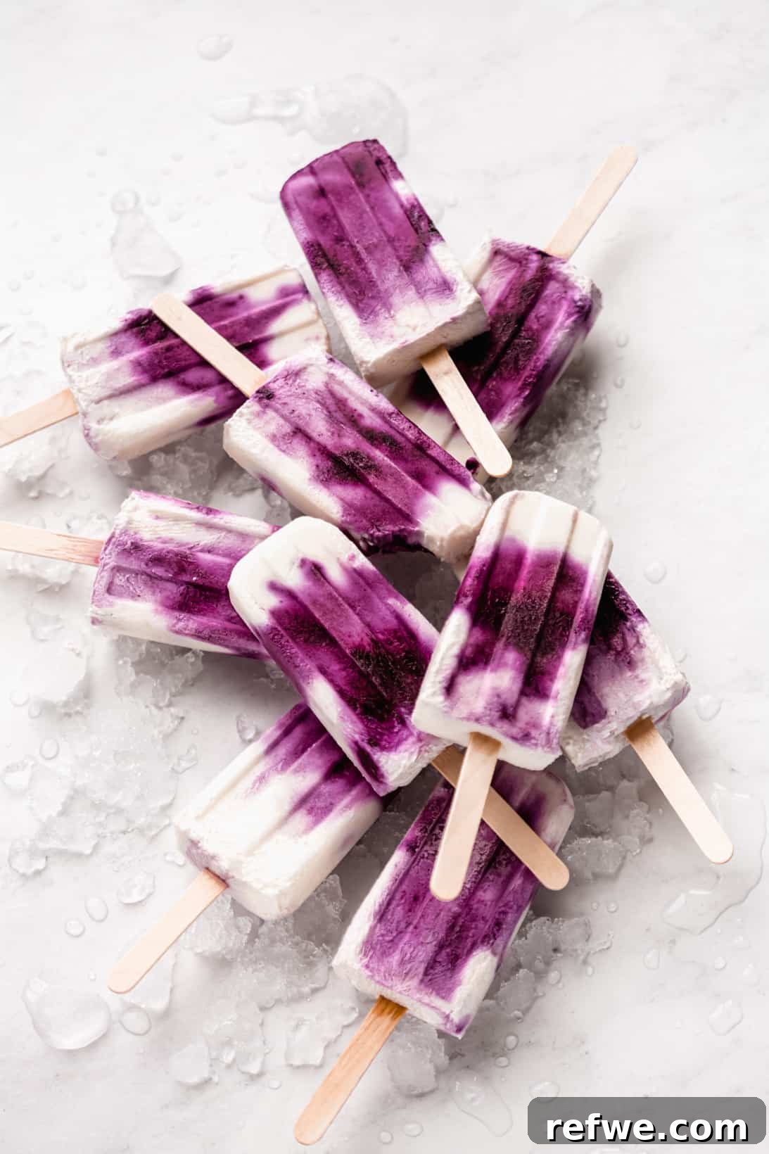 A beautifully arranged stack of blueberry Greek yogurt popsicles, ready to be served