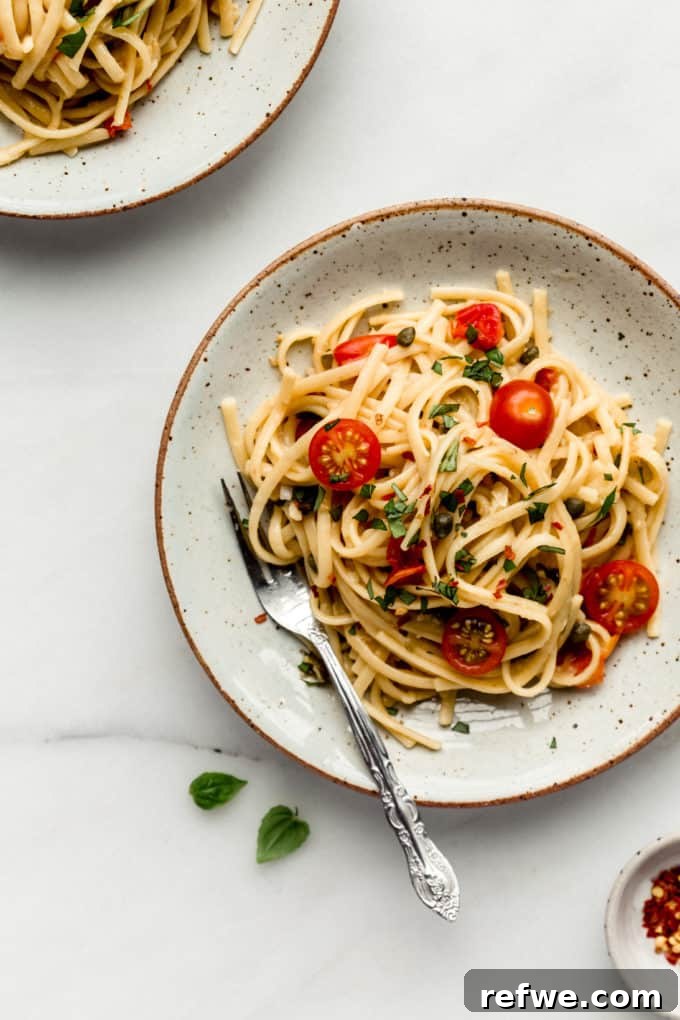 Effortless One-Pan Tomato Basil Pasta 6 A close-up of a plate filled with perfectly cooked pasta and bright cherry tomatoes, highlighting the freshness of the ingredients.