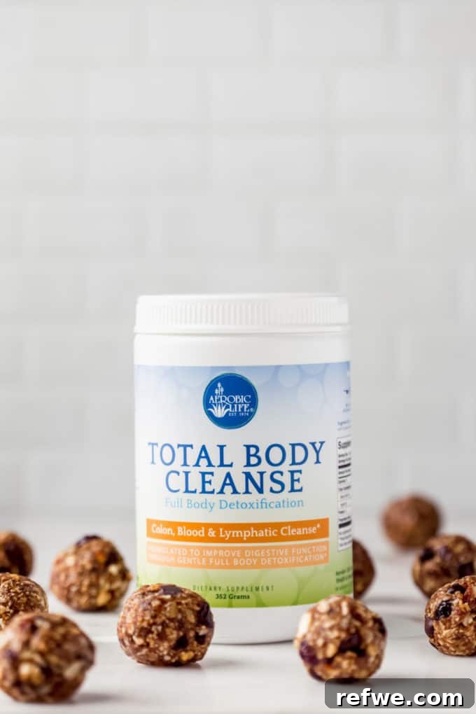 Trailblazer's Power Pods 3 A jar of Nutritional Brands Total Body Cleanse powder surrounded by a scattering of homemade trail mix energy balls, highlighting the key ingredient.