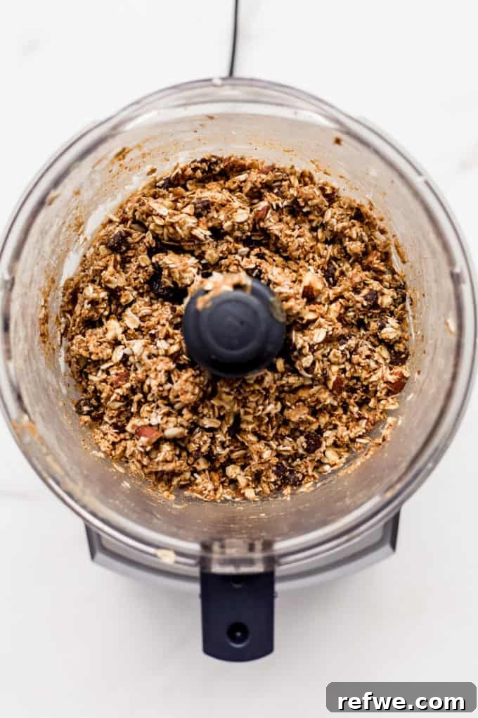 Trailblazer's Power Pods 5 The food processor bowl now contains a finely processed, sticky mixture of nuts, seeds, and dried fruits, ready to be rolled into energy balls.
