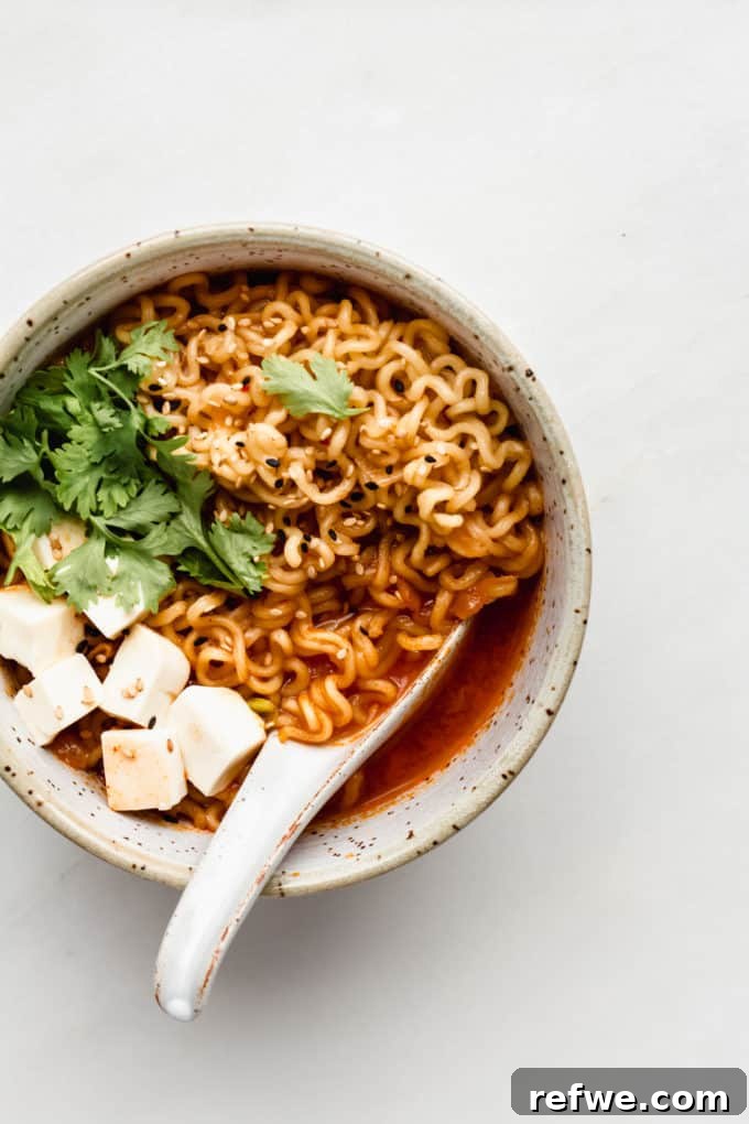 Fiery Kimchi Ramen 8 A beautifully presented bowl of Kimchi Ramen with bouncy noodles, perfectly cubed tofu, and a sprinkle of green onions.