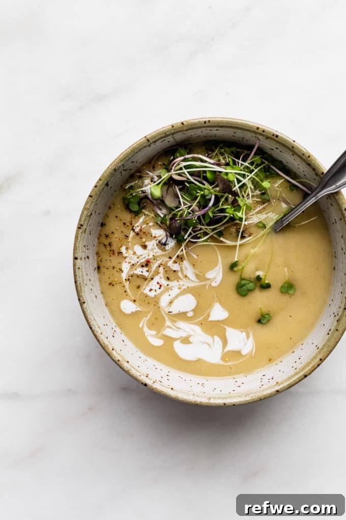 Comforting Slow-Roasted Garlic Soup 7 roasted garlic soup in a speckled light blue bowl