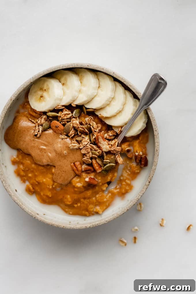 Autumn Pumpkin Spice Oats 5 pumpkin oatmeal in a bowl topped with bananas and granola, invitingly ready to eat