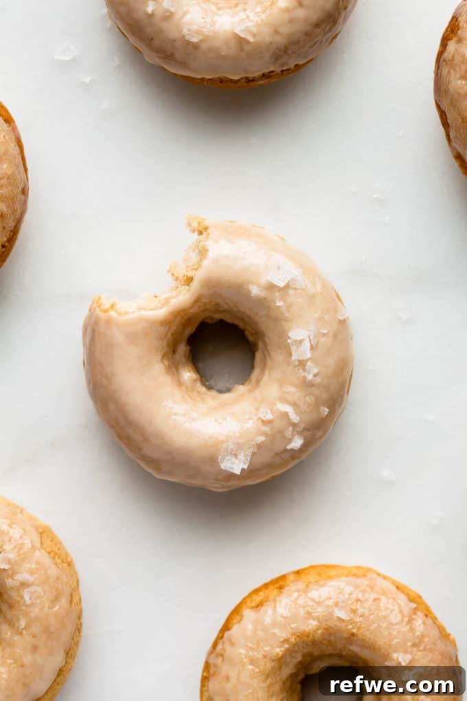 Sweet & Salty Vegan Maple Rings 4 Glazed maple donuts with sea salt on a marble serving board