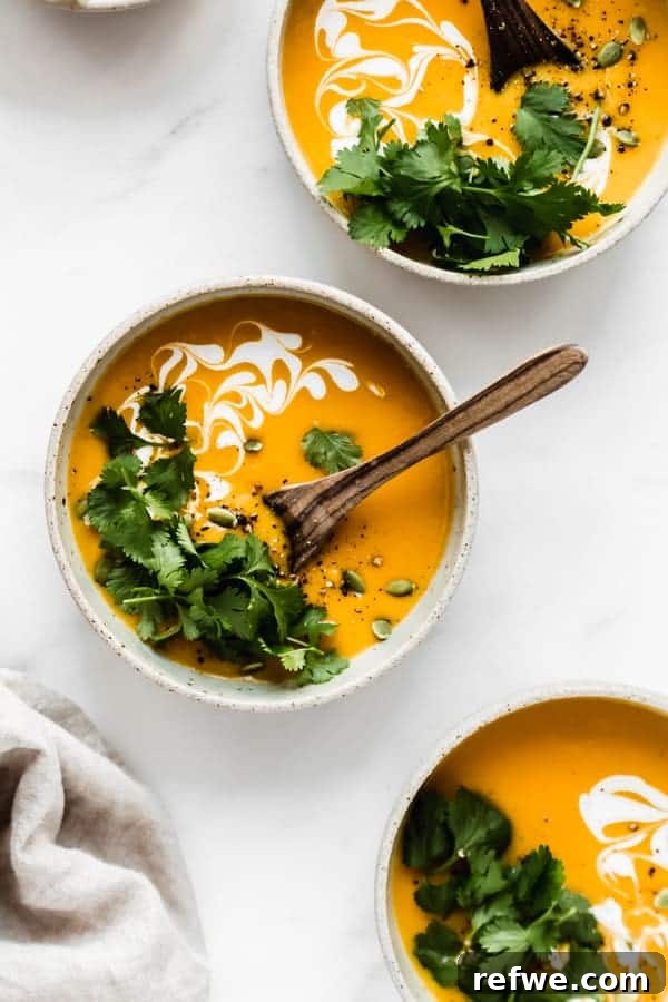 Heartwarming Plant-Based Soups for Cozy Days 20 A smooth, creamy butternut squash soup in a bowl with a swirl of cream or coconut milk.
