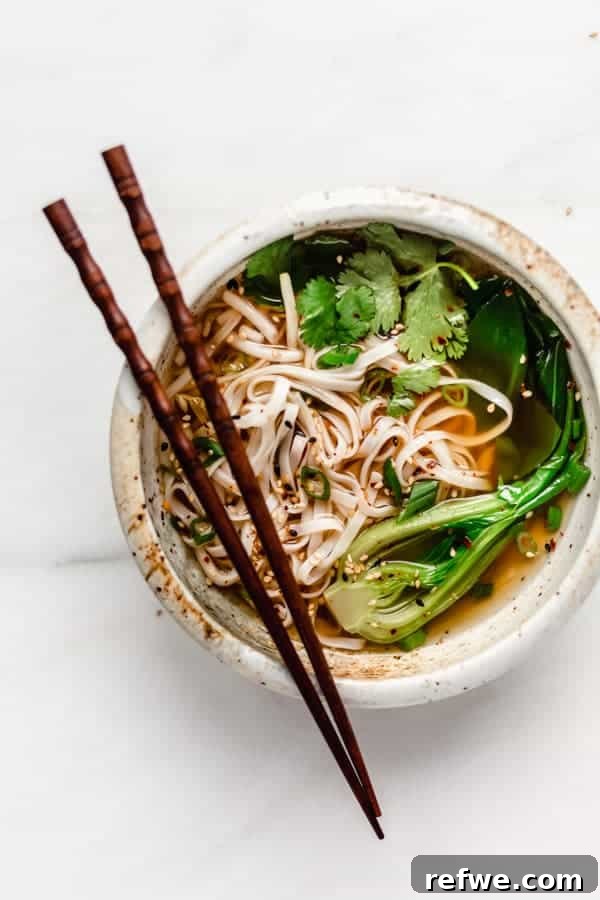 Heartwarming Plant-Based Soups for Cozy Days 3 A vibrant bowl of vegan pho with rice noodles, fresh vegetables, and broth.