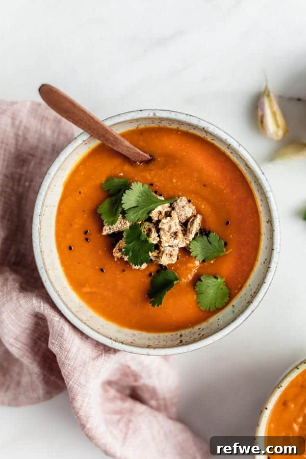 Heartwarming Plant-Based Soups for Cozy Days 22 A warm bowl of orange spiced carrot, lentil, and sweet potato soup.