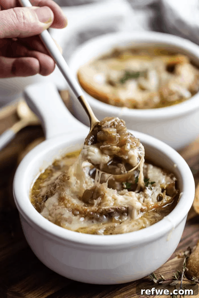 Heartwarming Plant-Based Soups for Cozy Days 4 A hearty bowl of vegetarian French onion soup topped with a melted cheese crouton.